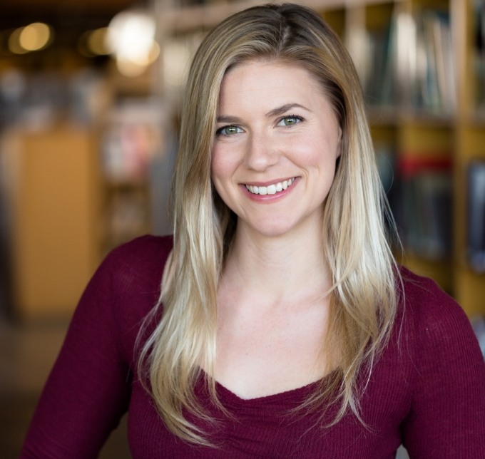 Blonde woman in maroon shirt smiling