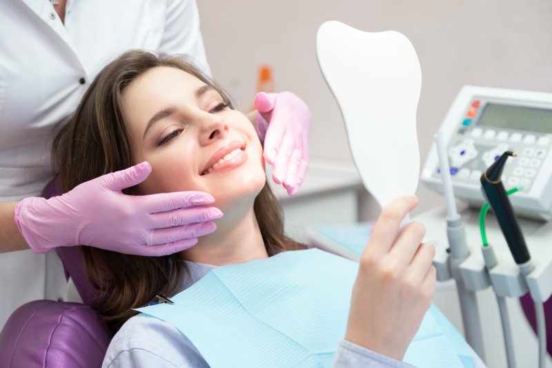 a woman smiling after receiving cosmetic dentistry