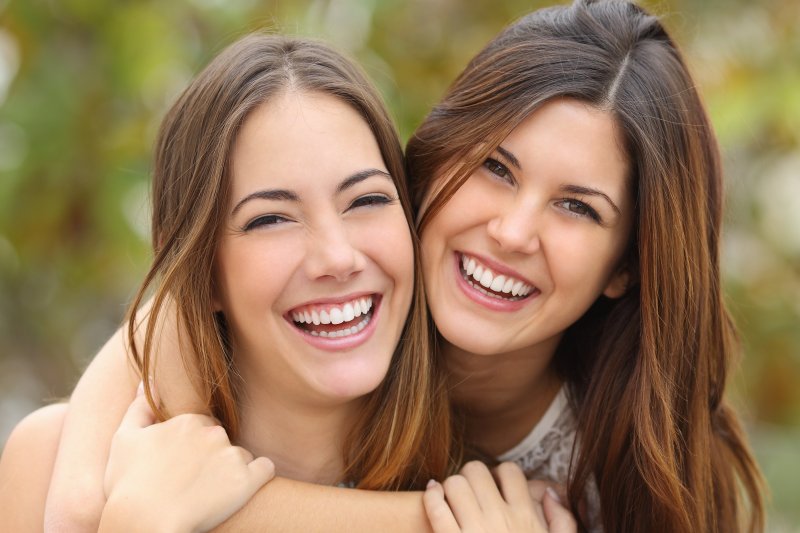 two women showing off their transformed smiles